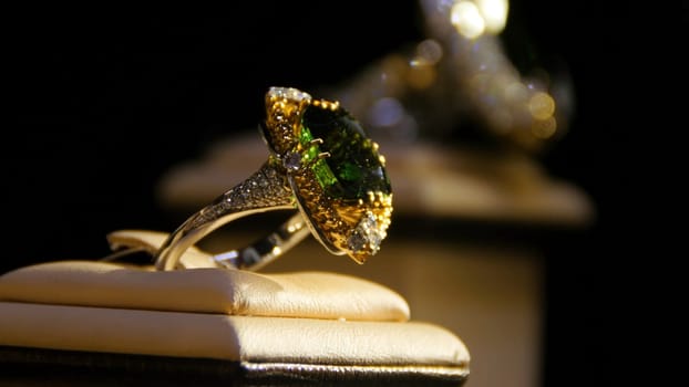 Jewelry with emeralds and diamond. Gemstones. Gold ring with emerald.