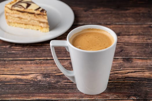 Relaxing americano coffee in white porcelain cup on wooden table