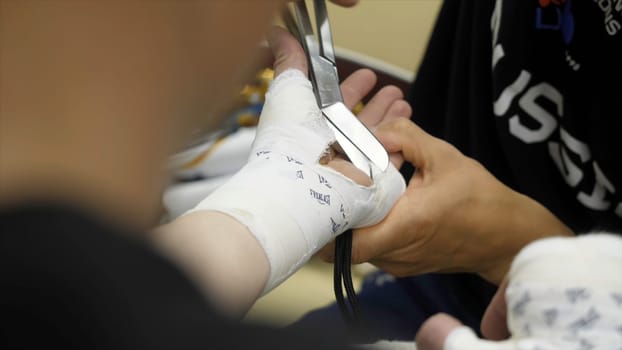 Boxing Trainer or Manager Wrapping Hands of a Boxer Close Up Shallow Depth of Field - Preparing For Boxing Match - Doctor Wrapping Possible Fractured or Broken Hand of Injured Person.