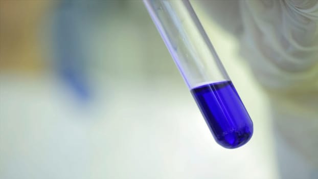 Test tubes closeup. Medical equipment. Close-up footage of a scientist using a micro pipette in a laboratory. Laboratory technician injecting liquid into a microtiter plate. Test tubes. Doctor at hospital checked sample in machine above view.