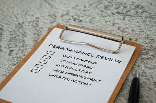 Performance Review checklist on clip board with pen. Performance review concept