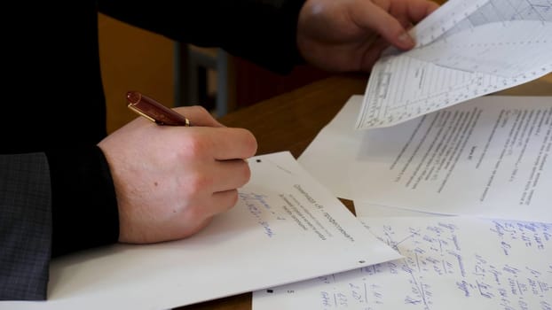 Businessman working with documents in the office. Close up of Young Businessman Using Calculator In Office.
