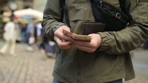 Man On Street Pulls Out Euro From Wallet And Counts Them