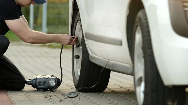 Man Lifts Car With Jack On Street As Driver Replaces Wheel