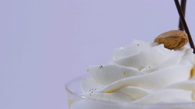 Vanilla sundae ice cream in cup on background. Ice cream in a glass with cream, closeup.