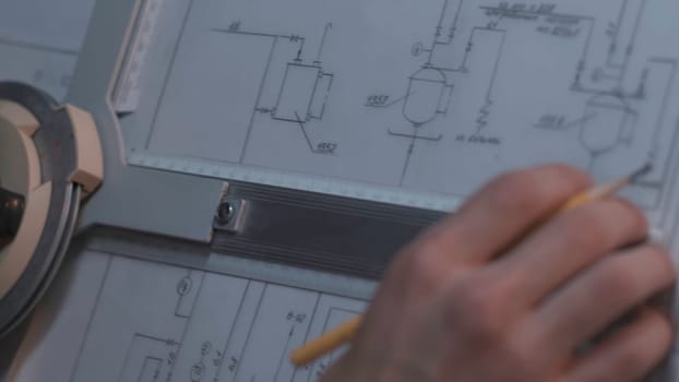 Close up of Architect hand sketching a construction project at work place. repair, building and home concept - close up of male hands making changes to blueprint
