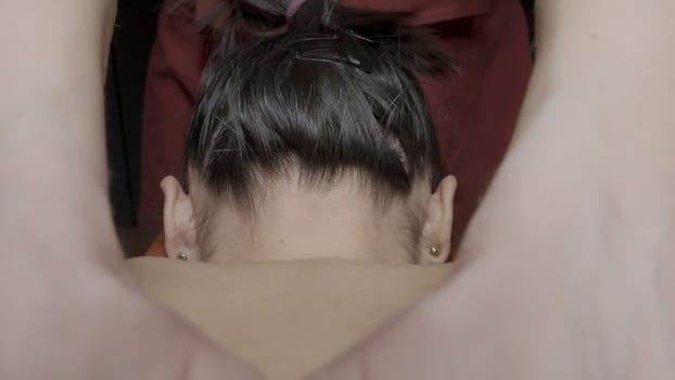 View from back to massage. Action. Woman is lying on relaxing massage in spa salon. Relaxing massage with smoothing movements of specialist's hands.