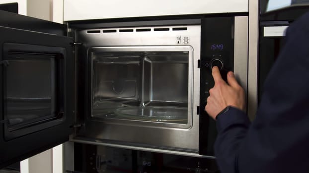 Close up of demonstrating the space inside the empty microwave oven. New model of a microwave, concept of technologies for home use.