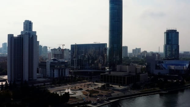 A big city with an embankment and a river. Stock footage. Bird's-eye view of tall office and residential buildings in the Art Nouveau style and the embankment for tourist walks. High quality 4k footage