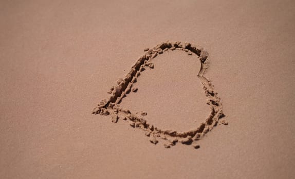 Drawn heart on wet sand on beach. Love for sea travel concept