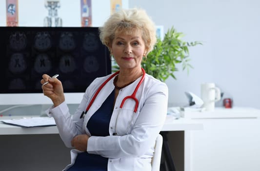 Portrait of elderly woman doctor in field of medicine. Brain examination and dementia concept