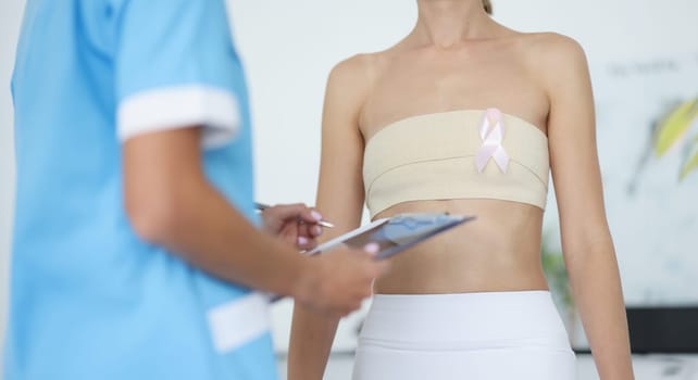Doctor examination of female breast and oncology. Mammologist and breast cancer symptoms and diagnosis concept