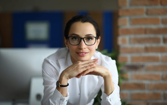 Portrait of beautiful businesswoman in glasses in office. Business consultant or bank employee