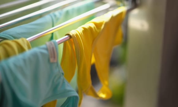 Clean washed clothes are dried in metal dryer closeup. Modes for washing clothes concept