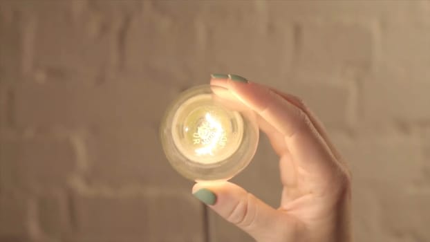 Hand turning off the bulb lamp.Turning off the light. Male hand turn on a light bulb. new idea concept with female hand holding light bulb. Switch