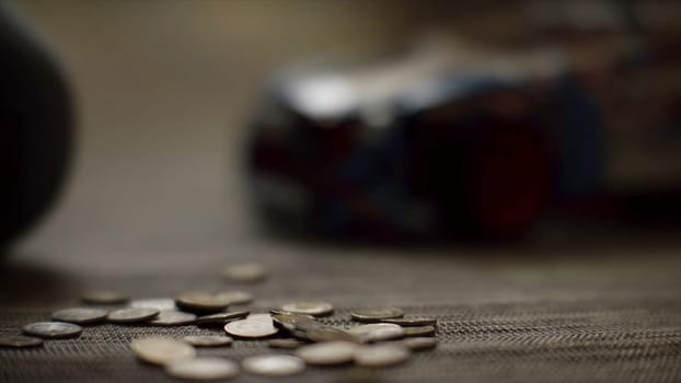 Close up for women hands putting money on the floor, saving money concept. Woman hands putting coins on the floor on blur background
