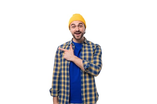 young brutal brunette man with a beard and mustache surprised on white background with copy space.