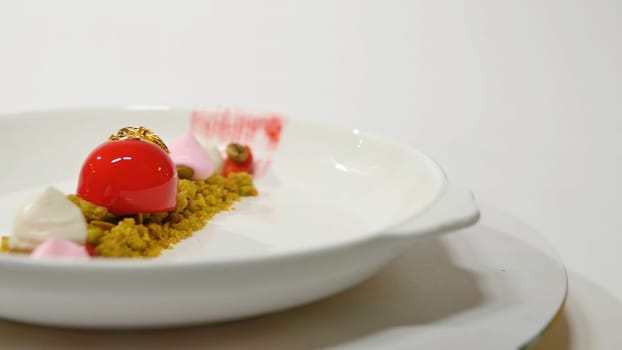 Dessert on the plate on white background. Beautiful delicious dessert on the plate. The presentation of the desserts in the United Arab Emirates.