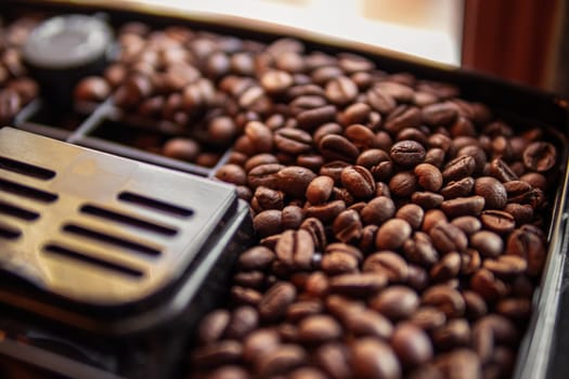 coffee beans in a coffee machine close up, close up of coffee beans in a coffee maker. High quality photo