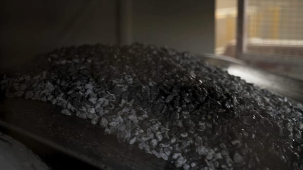 Gravel on the conveyor belt. Elements of equipment for the extraction and sorting of rubble, production of construction materials at the factory.