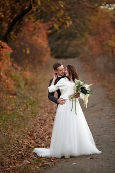 beautiful bride in white wedding dress and groom kissing