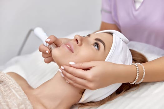 beautiful woman getting microdermabrasion procedure in a beauty spa salon