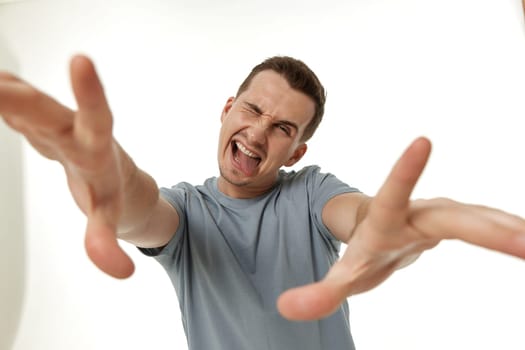 portrait of young happy man winking looking at the camera on white background