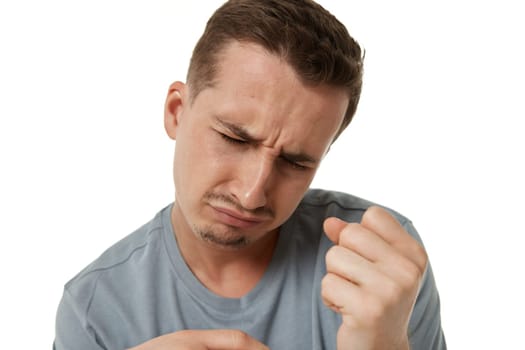 Portrait of offended frustrated young man on white background.