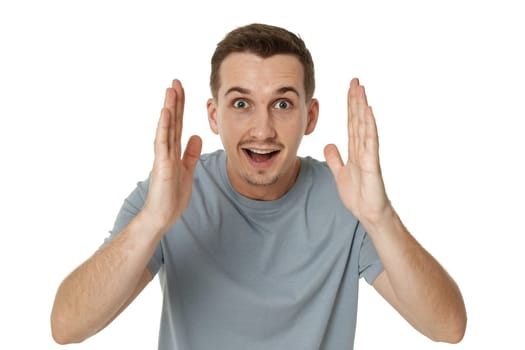 surprised guy looking at camera on white studio background