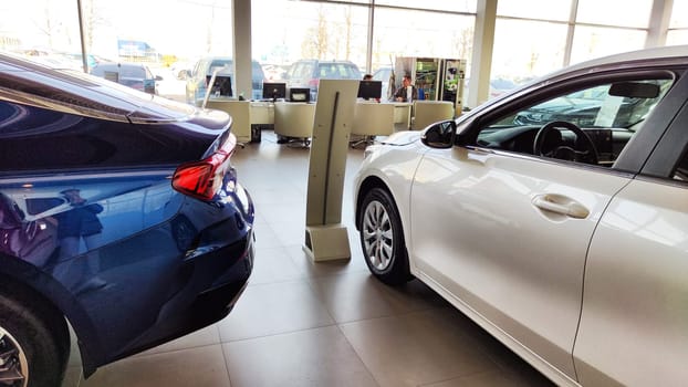 Cheboksary, Russia - April 05, 2023: Cars in showroom of dealership KIA. Re-export to Russia