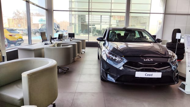 Cheboksary, Russia - April 05, 2023: Cars in showroom of dealership KIA. Re-export to Russia