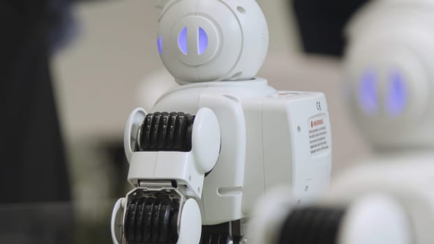 SHANGHAI - JUNE 28 2018: A small robot with human face and body - humanoid. Closeup of an cute autonomous service robot. Close-up of robot head.