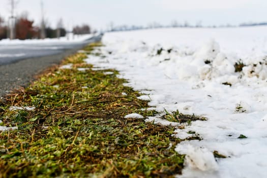 Road raked by snow plough in winter. Roads cleared by plough in winter. Concept of winter and winter road care.