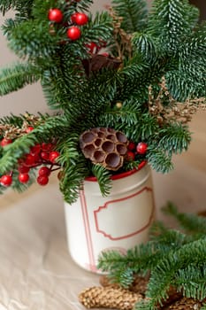 Homemade christmas decorations on table. Christmas bouquet in vase