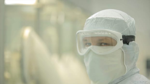 Pharmaceutical industry. Male factory worker inspecting quality of pills packaging in pharmaceutical factory. Automatic tape to create packaging and filling of medicines. control in the factory of medicine HD
