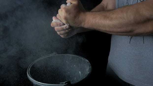Talc sports. Closeup of a muscular man ready to workout. male powerlifter hand in talc and sports wristbands preparing to bench press. Hands in chalk. male powerlifter hand in talc and sports wristbands preparing to bench press