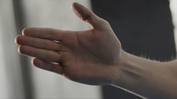 Action of man posture in guard by palm in karate style, close up. Man stood in martial art position.