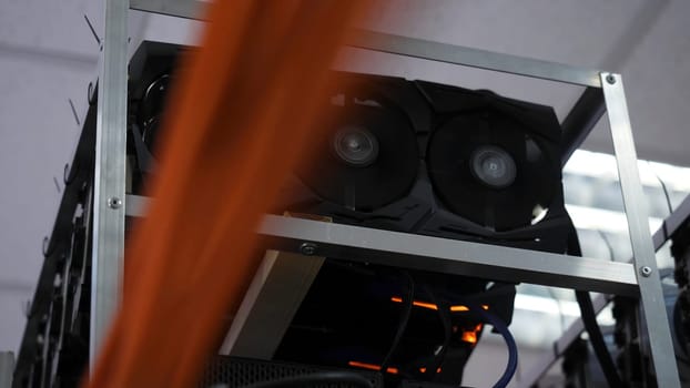 Close-up of mining farm. Electronic computer devices with fans and graphics processors with video cards for mining farms and cryptocurrencies.