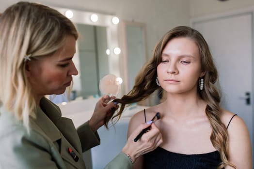 Make-up artist work in the studio with model