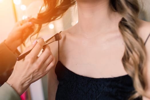 Make-up artist work in the studio with model