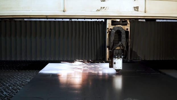 Cutting of metal. Sparks fly from laser. Clip. Laser cutting machine technology. Industrial Laser cutting processing manufacture technology of flat sheet metal steel material with sparks. Laser close-up.