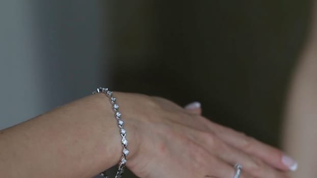 Wedding bracelet and necklace. Woman trying on jewelry bracelet. Bride with treasure. Woman with jewelry. Girl with fashionable jewelry, earrings, bracelets and necklace HD