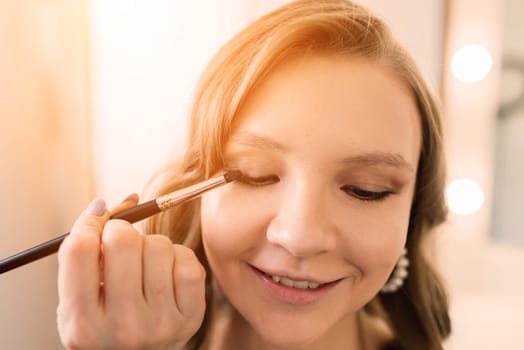 Make-up artist work in the studio with model