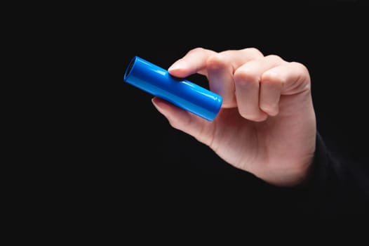 hand holds a charged electric battery. female hand showing empty battery mockup for advertising, close-up.