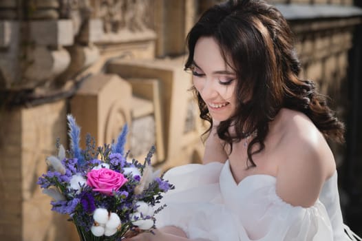 Stunning young bride with bouquet, portrait of smiling bride, happiness, wedding.