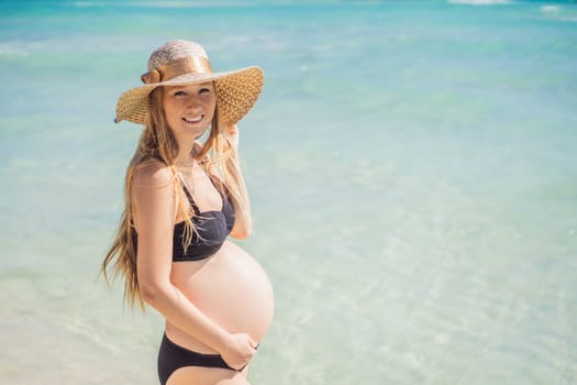 Radiant and expecting, a pregnant woman stands on a pristine snow-white tropical beach, celebrating the miracle of life against a backdrop of natural beauty.