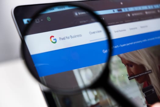 Google Pixel for Business logo on the screen of laptop through magnifying glass, December 2023, Prague, Czech Republic