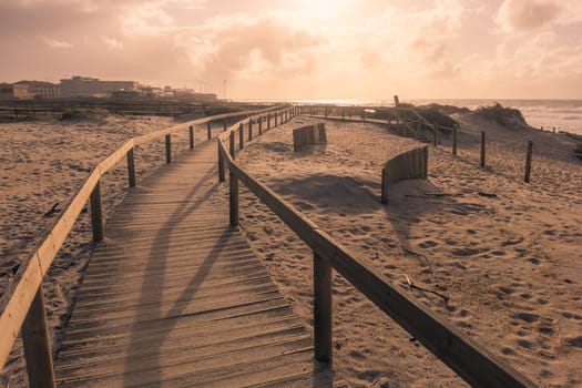 Wooden pathway leading to the beach on the throught the sand dunes at Furadouro - Ovar, Portugal.