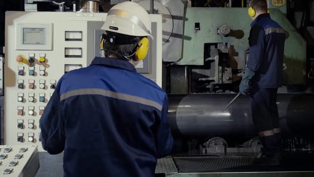 Two workers in production plant as team discussing, industrial scene in background. two worker in factory on the machine. Worker with out safety equipment caught in the machine HD