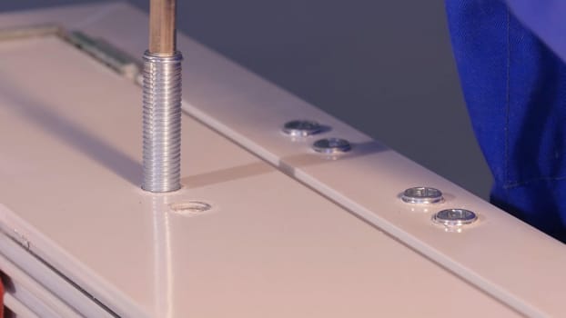 Installation Accessories For Plastic Pvc Windows. Screwdrivers or Drill. Male Hands Fasten Window Handle By Electric Screwdriver. Tempered float glass panels. Industry
